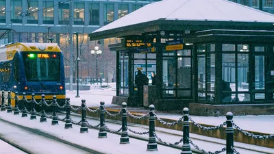 Tramway navigating through a snowy urban setting in Minneapolis, MN.