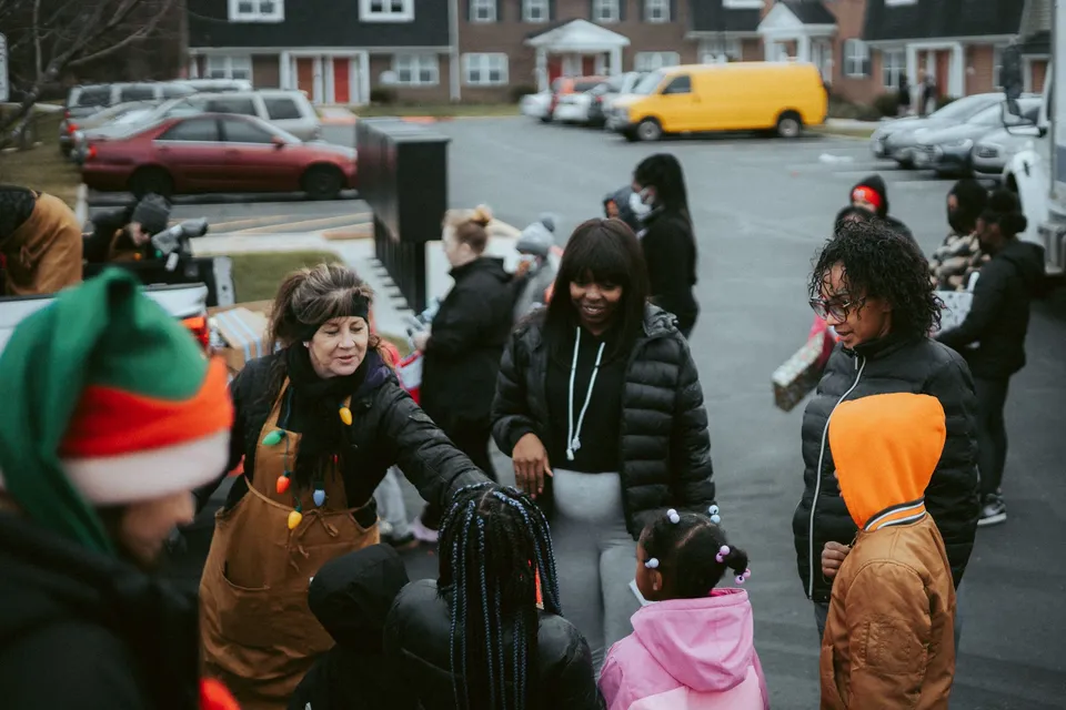 A diverse group of people enjoying a winter gathering outdoors.